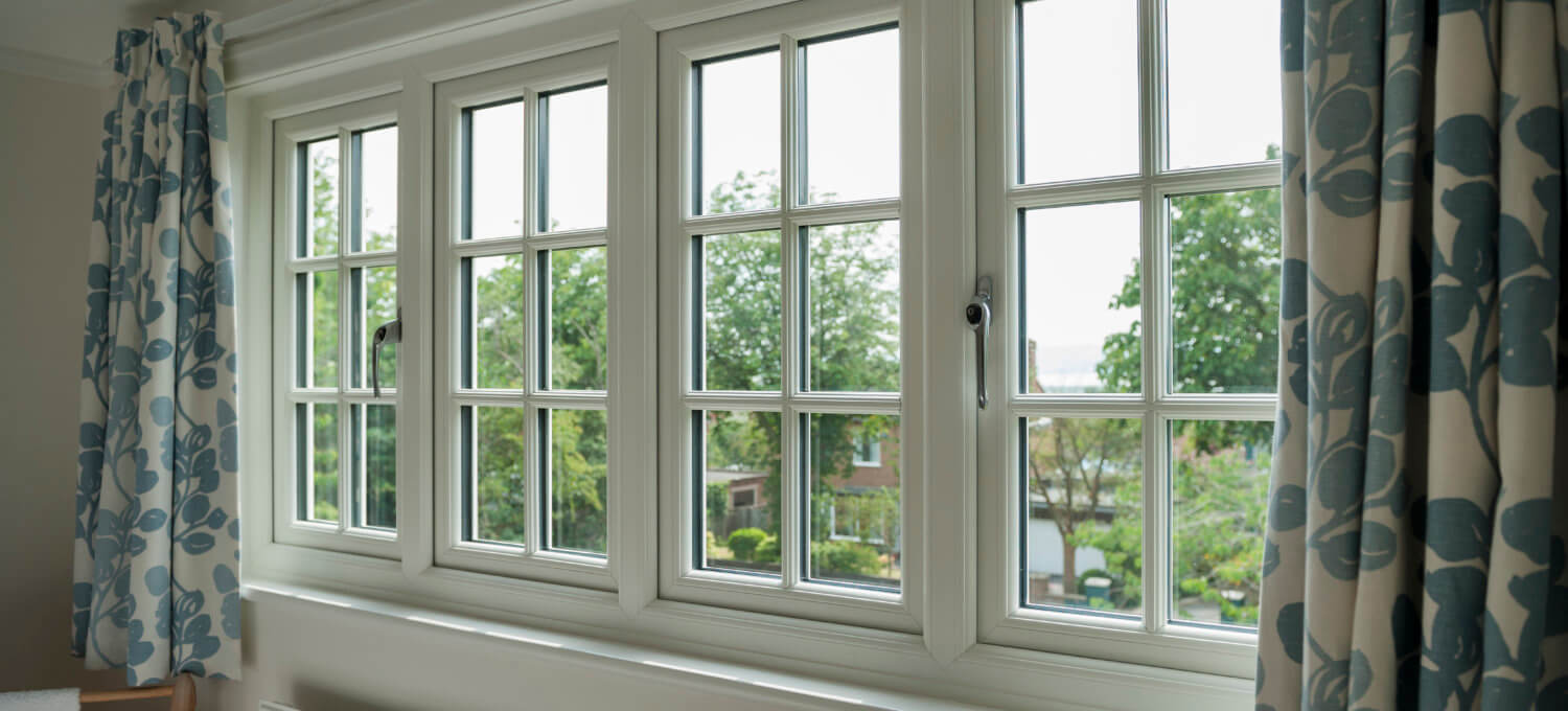 Interior view through a cream uPVC casement window looking onto a garden